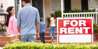 Family of four walking into home with for rent sign