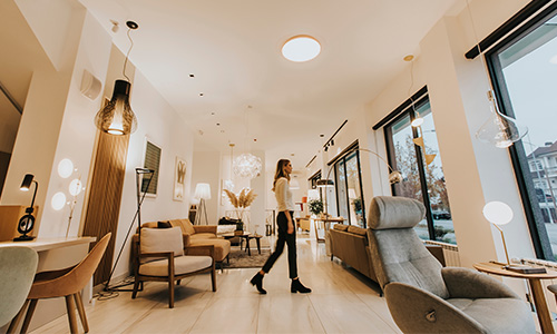 A woman walking through her living room. 