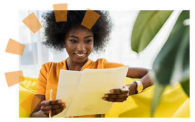 A woman in orange holding paperwork. 