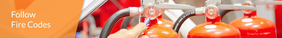 Person inspecting fire extinguishers on a jobsite.