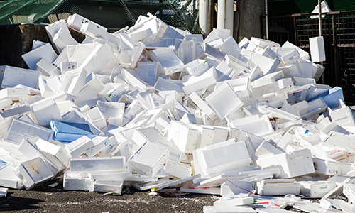 A pile of Styrofoam on asphalt.