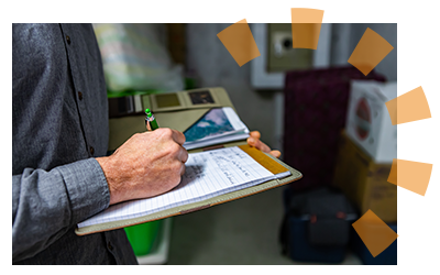 A person writing notes as he inspects a foreclosed home.