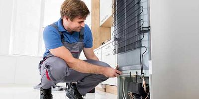 Professional removing Freon from a refrigerator. 