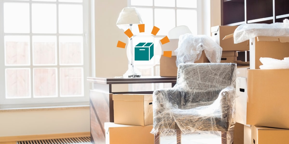 A room full of moving boxes and furniture.