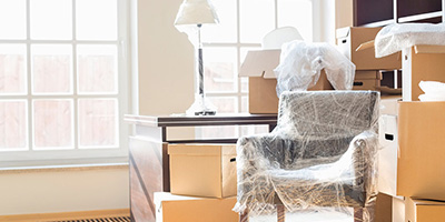 A room full of moving boxes and furniture. 