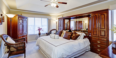 A dated master bedroom full of old furniture to get rid of.