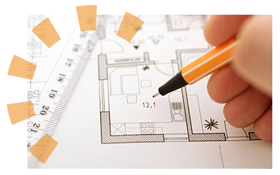 A person looking at blueprints to plan their home demolition