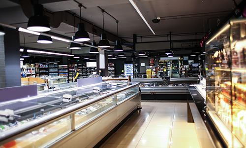 The freezer and cooler aisle of a modern grocery store.