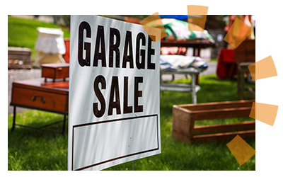 A sign that says "Garage sale" with old bedroom furniture being sold in the background.