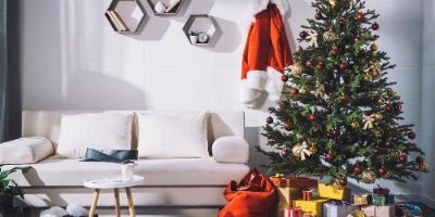 White Room With Minimalist Furniture and a Christmas Tree With Presents