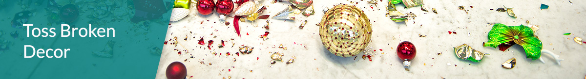 Broken Christmas tree ornaments on a tile floor.