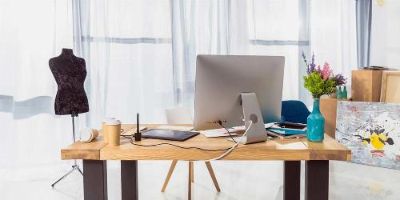 Desk With Mild Clutter in a Home Office. Source: Deposit Photos