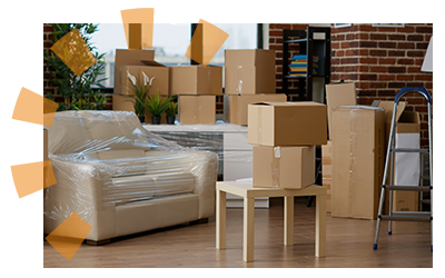 A packed up living room with multiple moving boxes and furniture wrapped in transporting plastic.