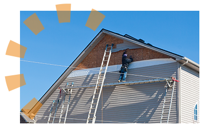 Homeowner on extension ladder removing vinyl siding.