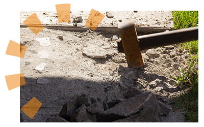 Homeowner using sledgehammer to break-up old concrete patio.