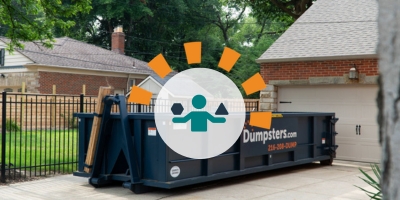 Dumpsters.com Roll Off Dumpster Sitting in Driveway Outside of Home