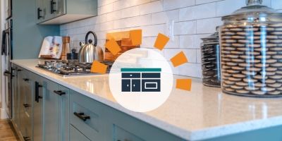 A shiny white countertop with a tea kettle in the background.