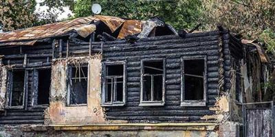 Burned Home Surrounded by Trees.