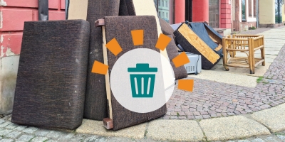 An assortment of couches and other bulky debris on a street corner.