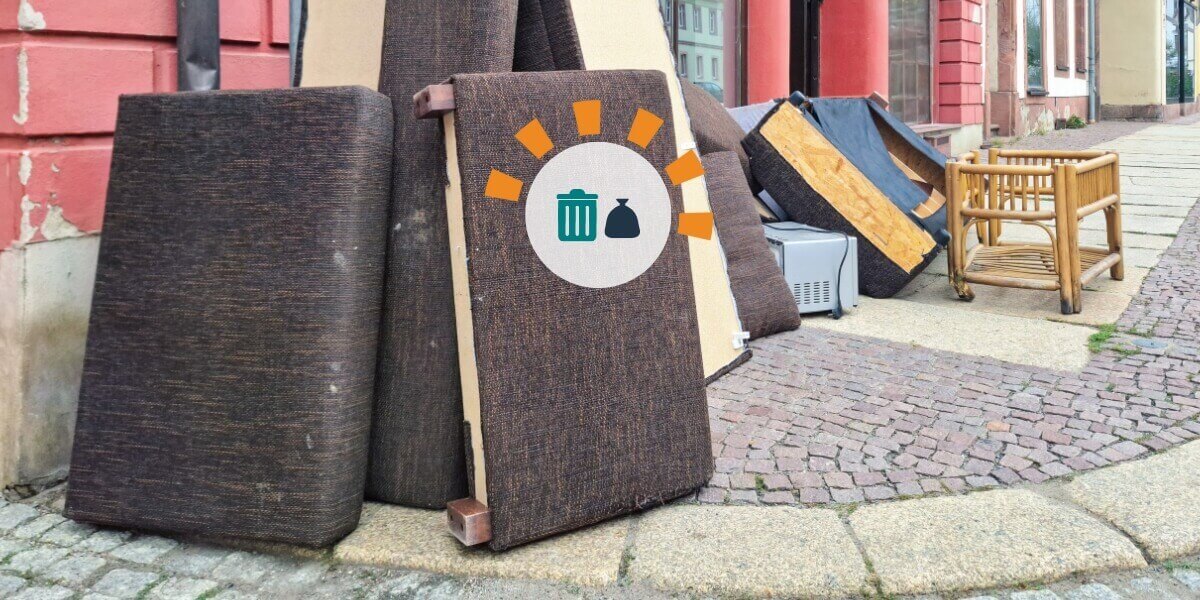 An assortment of couches and other bulky debris on a street corner.