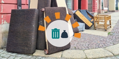 An assortment of couches and other bulky debris on a street corner.