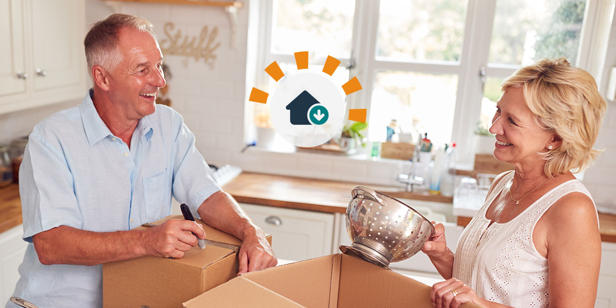 A senior couple packing materials to downsize from their old home. 