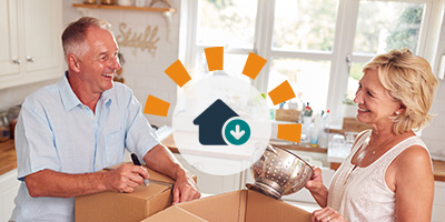 A senior couple packing materials to downsize from their old home. 