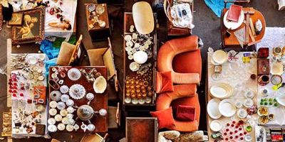 Birds Eye View of Dishes, Furniture and Odds and Ends Displayed at a Garage Sale.