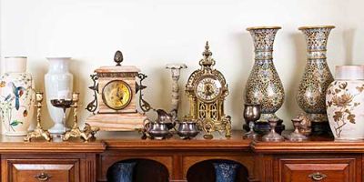 Antique Vases and Clocks Displayed on an Antique Chest.