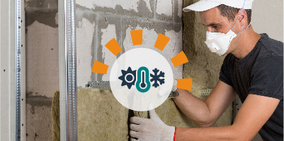 Man wearing mask and gloves working on garage insulation job.