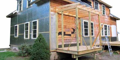 Two-Story Home with Small Room Being Built Onto the Side.