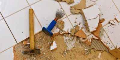 Hammer and Chisel Being Used to Remove Floor Tile