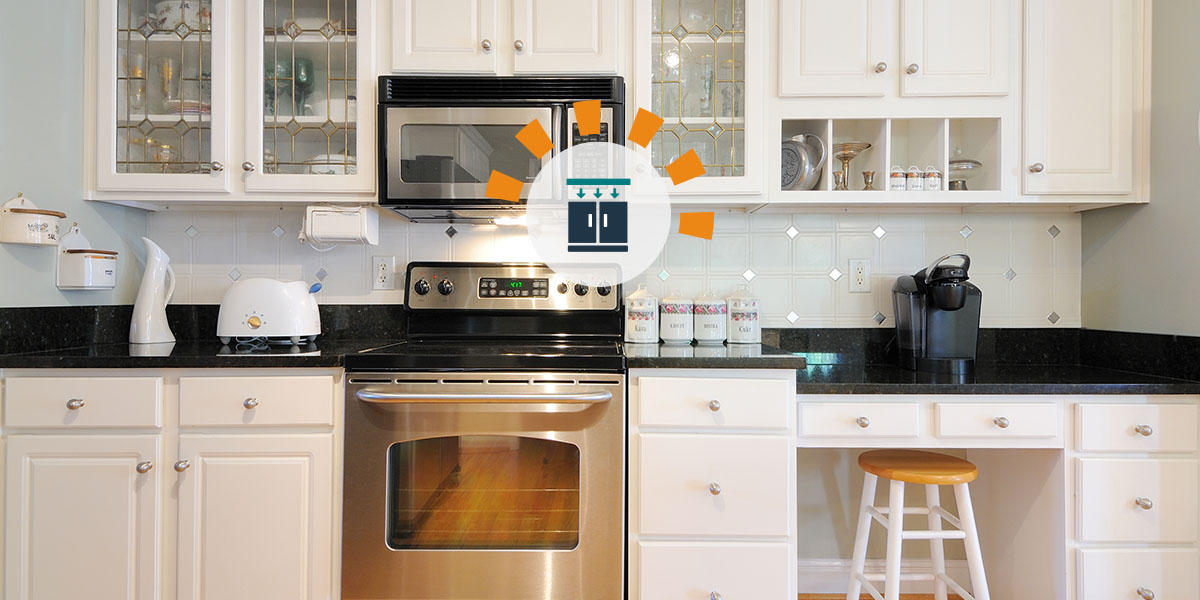 Black laminate kitchen countertops on top of white cabinets.