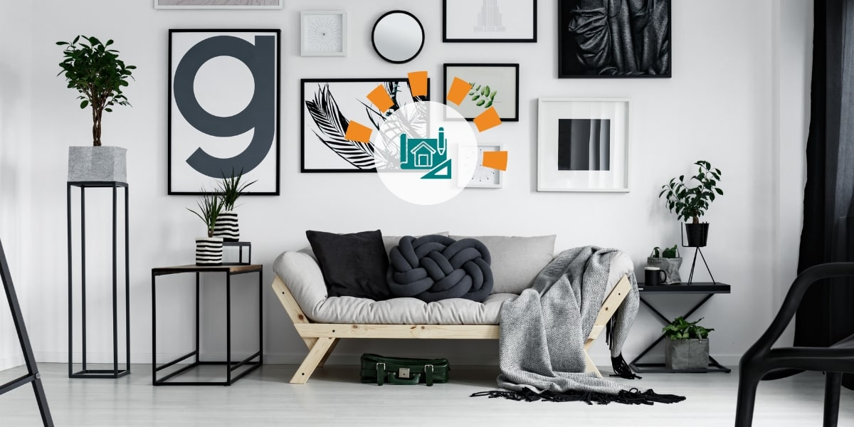 Black, white and grey living room designed with sofa, chair, tables, artwork and plants by interior decorator for blog website.
