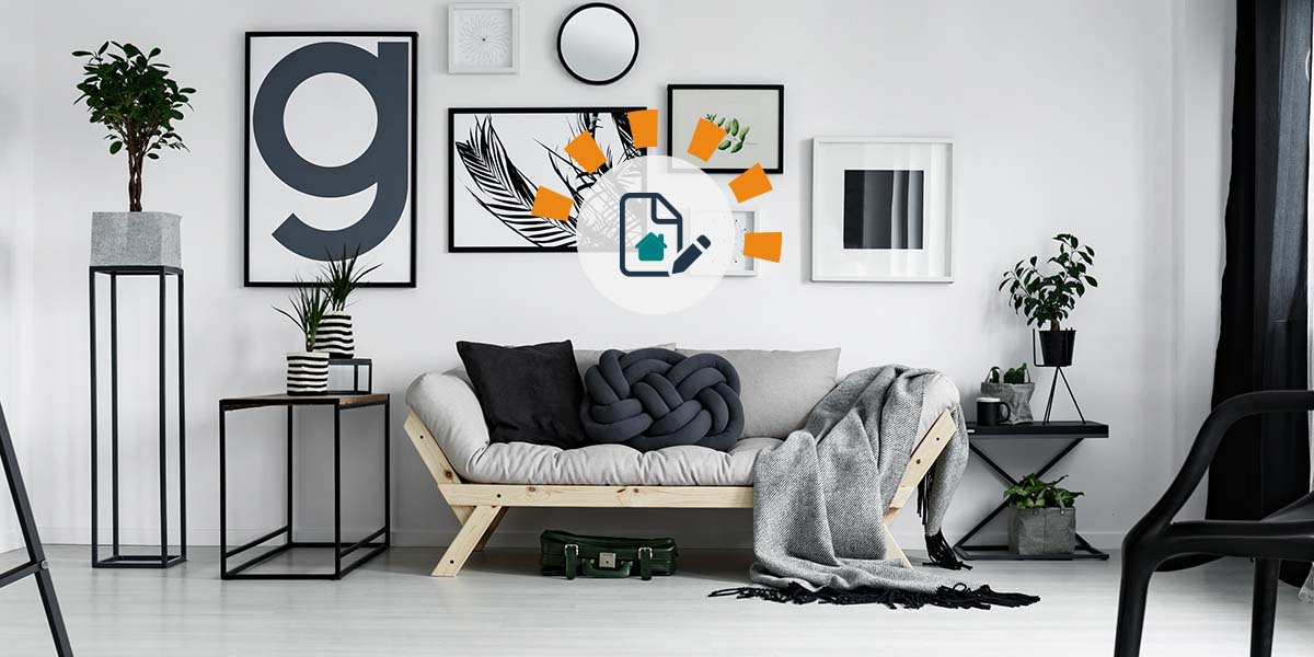 Black, white and grey living room designed with sofa, chair, tables, artwork and plants by interior decorator for blog website.
