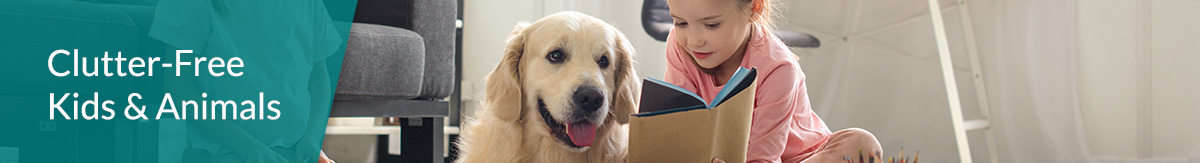 Child with dog reading on living room floor in a clutter-free home.