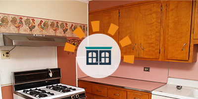 Old wooden kitchen cabinets with a salmon colored countertop and backsplash.
