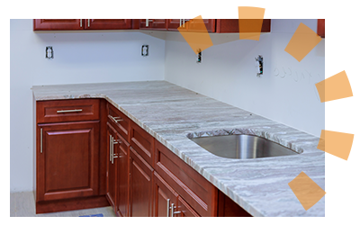 Red kitchen cabinets with a marble countertop.