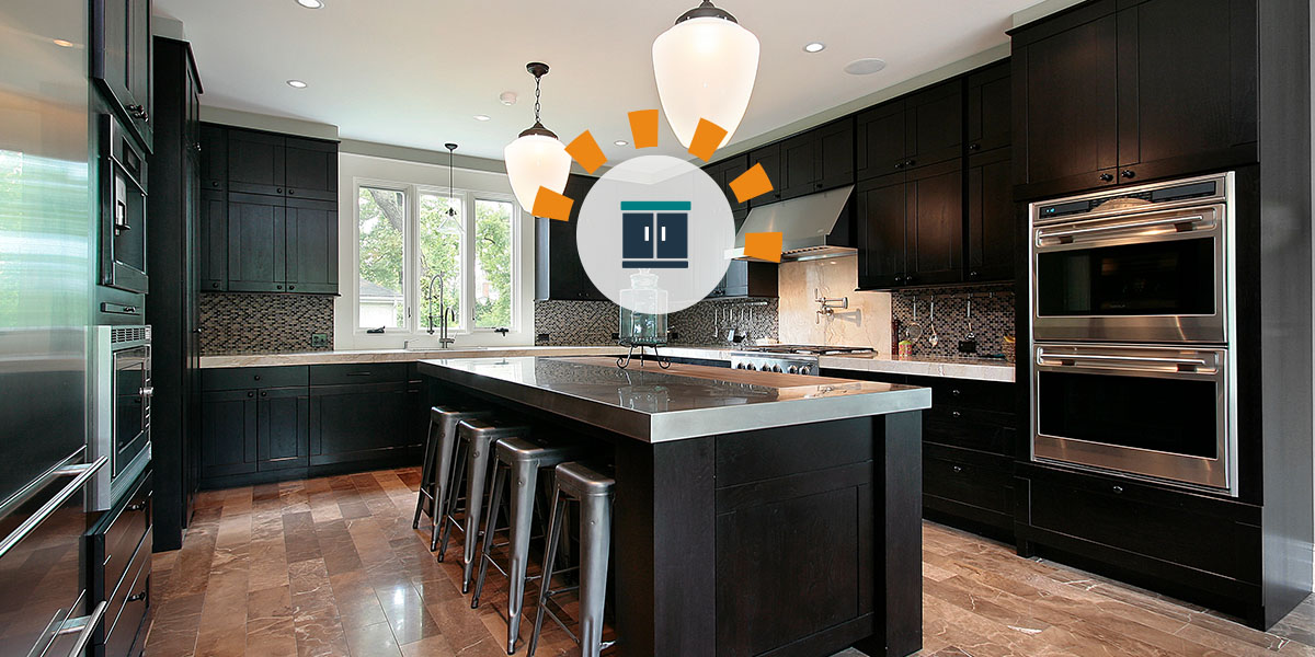 A modern kitchen with black cabinets and stainless steel countertops.