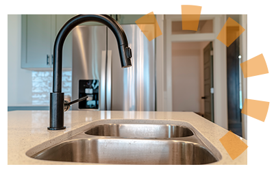 A set-in sink with tan countertops.