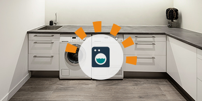 Laundry Room With White Appliances and Wood Cabinets.