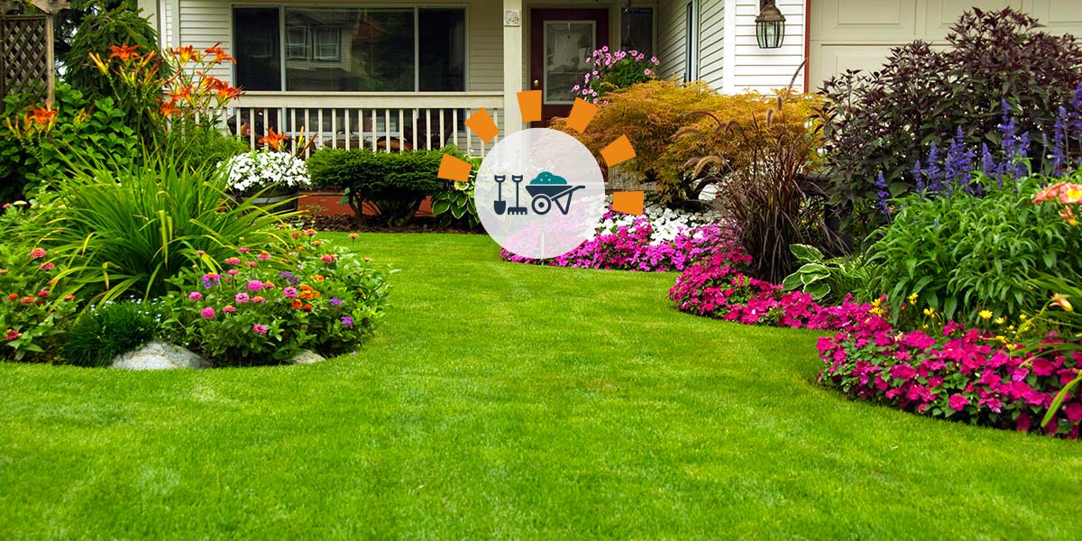A well-manicured lawn with flowers, bushes and small shrubbery for landscaping accents.