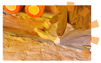 Man laying down fiberglass batting insulation between joists in attic floor.