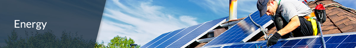 Man installing solar panels on the roof of a residential home for energy efficiency.