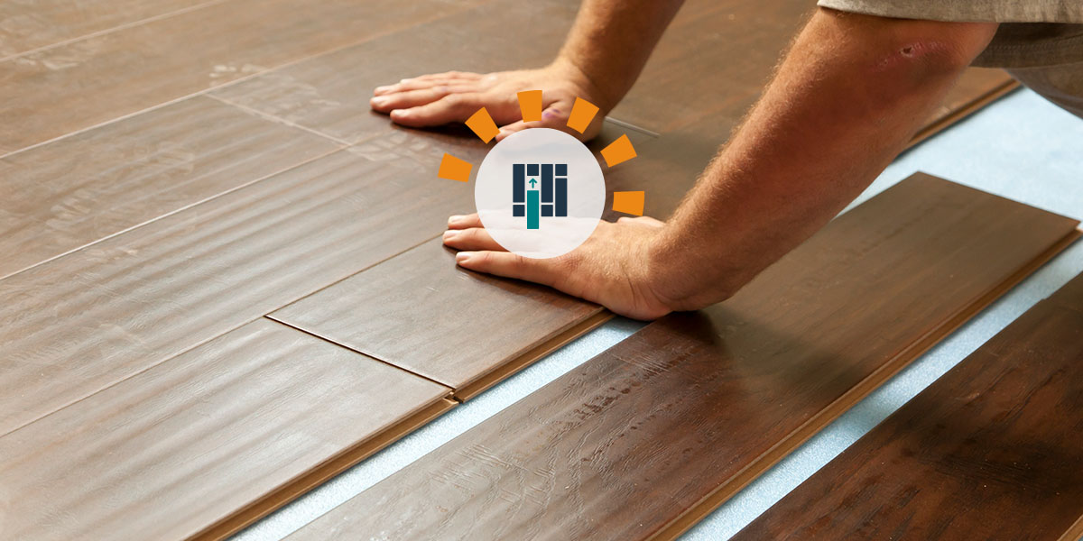 A man installing vinyl plank flooring. 