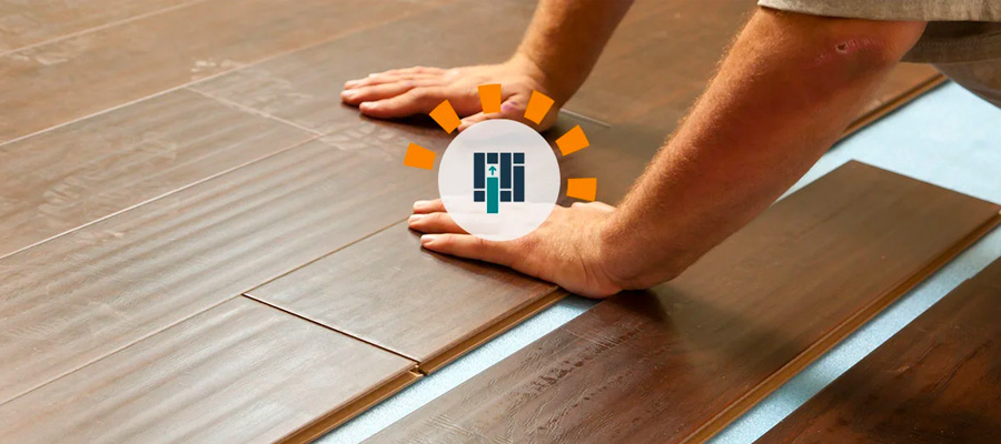 A man installing vinyl plank flooring. 