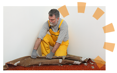 Man removing and rolling up old carpet.