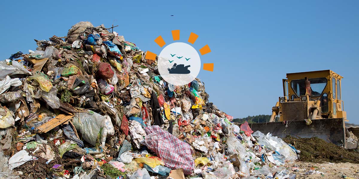 Pile of Debris in Landfill With Truck in Background.