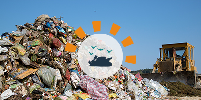 Pile of Debris in Landfill With Truck in Background.