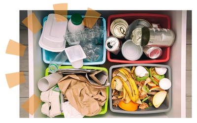 Birdseye View of Four Garbage Cans Filled With Cans, Bottles, Paper and Food Waste